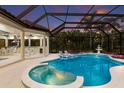 Stunning screened pool area with outdoor kitchen and bar, perfect for entertaining and relaxation at 7011 Belmont Ct, Lakewood Ranch, FL 34202