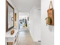 Bright hallway with tile flooring, featuring stylish decor and a glimpse into the spacious living area at 7218 Cloister Dr # 7218, Sarasota, FL 34231