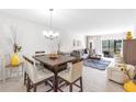 Open-concept living and dining area with contemporary furnishings and abundant natural light at 7218 Cloister Dr # 7218, Sarasota, FL 34231
