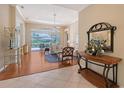 Bright living room with hardwood floors, neutral walls, and sliding glass doors to the outdoor patio at 7528 Ascot Ct, University Park, FL 34201