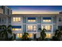 Beautiful townhome exteriors featuring blue awnings, private balconies, and lit windows at dusk at 845 Burlington N Ave, St Petersburg, FL 33701