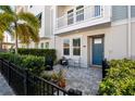 Inviting front porch with stone pavers, a blue door, and a cozy outdoor seating area at 845 Burlington N Ave, St Petersburg, FL 33701