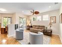Cozy living room with hardwood floors, neutral furniture, and a ceiling fan at 10008 Sugar Mill Dr, Bradenton, FL 34212