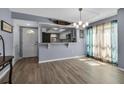 Bright living space featuring modern flooring, an open kitchen, and waterfront view at 10415 Waterbird Way # 10415, Bradenton, FL 34209