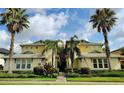 Two story yellow and cream building with manicured landscaping and palm trees around the building at 1264 Riverscape St # B, Bradenton, FL 34208