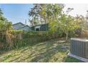 Spacious backyard featuring lush greenery, a wooden fence, and ample space for outdoor activities at 1330 16Th St, Sarasota, FL 34236