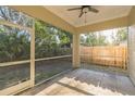 Enclosed back porch featuring a ceiling fan, durable tile flooring, and a serene outdoor view at 1330 16Th St, Sarasota, FL 34236