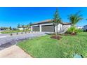 Beautiful single-Gathering home with lush landscaping and a paver driveway at 15507 Sunny Day Dr, Bradenton, FL 34211