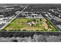 An aerial view showcasing the property lines of a large lot featuring lush greenery and mature trees around the perimeter at 16305 E State Road 64, Bradenton, FL 34212