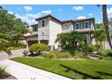Beautiful two-story home with a red tile roof, well-manicured lawn, and lush landscaping at 1719 Kenilworth St, Sarasota, FL 34231