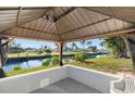 Captivating backyard gazebo with waterfront views, offering a serene outdoor space for relaxation and entertainment at 221 Duxbury Ave, Port Charlotte, FL 33952