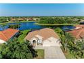 Gorgeous waterfront home with a tile roof, screened lanai and lush, mature landscaping at 251 Dove Trl, Bradenton, FL 34212