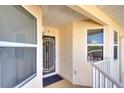 The entrance of the condo features security door, large window and classic tan stucco at 2608 Waterford Way # B, Palmetto, FL 34221