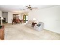 Spacious living room featuring carpet floors and comfortable seating area next to dining room at 2614 67Th W St, Bradenton, FL 34209