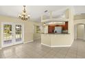 A combined living and kitchen area with tile flooring, granite countertops, and stainless steel appliances at 27255 Deep Creek Blvd, Punta Gorda, FL 33983