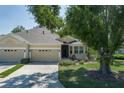 Charming single-story home with a two-car garage, complimented by mature trees and a well-kept lawn at 3312 92Nd E Ave, Parrish, FL 34219