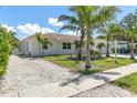 Exterior side view with ample parking and lush landscaping around the home at 3417 50Th W St, Bradenton, FL 34209