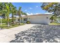 Well-maintained home with a two-car garage, manicured lawn, and sunny skies at 3417 50Th W St, Bradenton, FL 34209