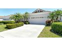 Charming single-Gathering home with a clean concrete driveway leading to an attached two-car garage at 3870 Alamanda Dr, Sarasota, FL 34238