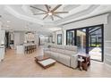Bright and airy living room with modern furniture, tiled floors, and sliding glass doors to the backyard at 4668 Tuscana Dr, Sarasota, FL 34241