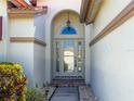 Stylish front door with decorative glass and transom window at 4729 Peridia E Blvd, Bradenton, FL 34203
