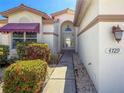 Attractive front entrance with well-maintained landscaping and a decorative glass door at 4729 Peridia E Blvd, Bradenton, FL 34203