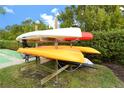 Colorful kayaks stacked on a wooden rack, perfect for residents' beach adventures at 4835 Gulf Of Mexico Dr # 106, Longboat Key, FL 34228