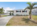 Charming single-story home featuring a covered carport and well-maintained landscaping at 517 Tampico Dr, North Port, FL 34287