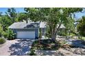 Lovely single-story home with a two-car garage, lush landscaping, and mature trees at 5324 Siesta Ct, Sarasota, FL 34242