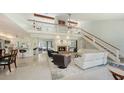 Bright, open living area with high ceilings, fireplace, and access to outdoor patio at 5324 Siesta Ct, Sarasota, FL 34242