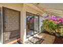 Welcoming front entry with a covered porch and decorative plants at 5354 Myrtle Wood # 50, Sarasota, FL 34235