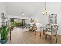 Bright living room featuring wood floors, vaulted ceilings and sliding glass doors at 5354 Myrtle Wood # 50, Sarasota, FL 34235