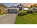 Charming single-story home with well-maintained landscaping and a gray two-car garage at 5919 100Th E Ave, Parrish, FL 34219