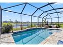Gorgeous in-ground pool with screened enclosure, overlooking a tranquil waterfront view at 5919 100Th E Ave, Parrish, FL 34219