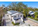 Charming single-story home nestled amongst lush greenery with a quaint outdoor seating area at 652 Ohio Pl, Sarasota, FL 34236