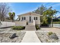 Charming home featuring neutral siding, inviting front porch, and a well-manicured lawn at 652 Ohio Pl, Sarasota, FL 34236