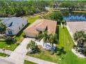 A serene view of the home, the lake, and the surrounding greenery creating a peaceful and inviting atmosphere at 6838 44Th E Ter, Bradenton, FL 34203