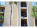 Exterior of condo building with palm trees, unit number, and balconies at 7803 Grand Estuary Trl # 205, Bradenton, FL 34212