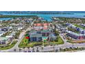 Aerial view of condo building showcasing the pool and nearby waterways at 845 Benjamin Franklin Dr # 106, Sarasota, FL 34236