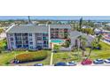 Exterior condo shot including the pool and lovely green space at 845 Benjamin Franklin Dr # 106, Sarasota, FL 34236