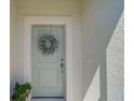 Stylish front door adorned with a wreath, creating a warm welcome to this inviting home at 8553 Whispering St, Sarasota, FL 34240