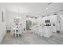 Open kitchen features white cabinets, stainless steel appliances, and a breakfast bar at 8553 Whispering St, Sarasota, FL 34240