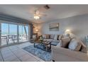 Comfortable living room with tile floors, slider to balcony and partial ocean views at 901 Gulf S Dr # 3, Bradenton Beach, FL 34217
