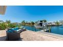 Beautiful waterfront backyard featuring a patio with comfortable seating and a private boat dock at 10008 Spoonbill E Rd, Bradenton, FL 34209