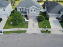 An aerial view of a gray home with well-maintained landscaping and a long driveway at 10934 79Th E St, Parrish, FL 34219