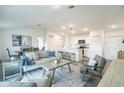 Open concept living room and kitchen with contemporary decor, tile floors, and ample natural light at 1098 Fletcher St, Port Charlotte, FL 33952