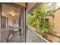 A peaceful porch view showcasing tropical greenery and glimpses of the home's dining area at 1711 Pelican Cove Rd # 443, Sarasota, FL 34231