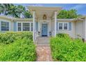 Close up shot of the front porch with stone walkway leading to the front door at 1960 Lincoln Dr, Sarasota, FL 34236