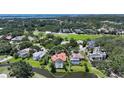 Beautiful aerial view of home, with enclosed pool, near the water and surrounded by golf course at 228 Saint James Park, Osprey, FL 34229