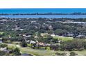 Aerial view of home on the golf course near the water, with serene landscaping at 228 Saint James Park, Osprey, FL 34229